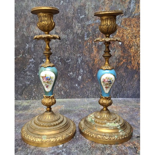 502 - A pair of 19th century gilt metal mounted and porcelain table candlesticks, in the Sevres manner, pa... 