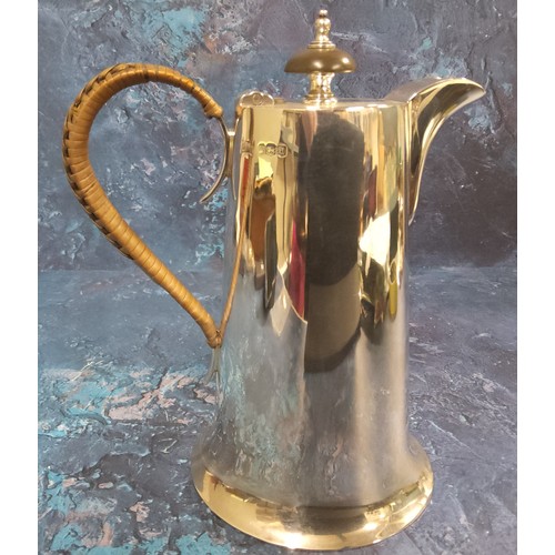 54 - A silver hot water pot and cover, spreading cylindrical form, hinged cover, wicker handle, Walker &a... 