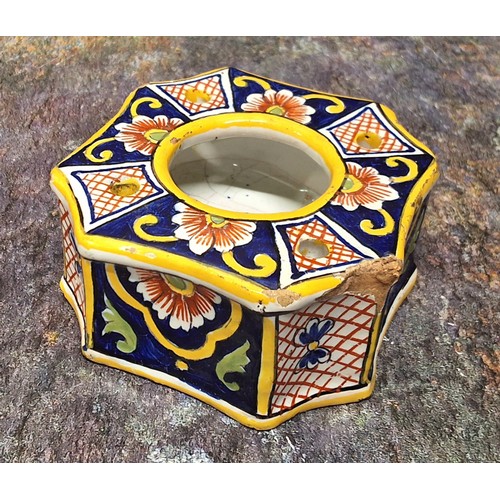 311 - A 19th century tin glazed oval inkwell, with two wells, decorated with stylised foliage in underglaz... 