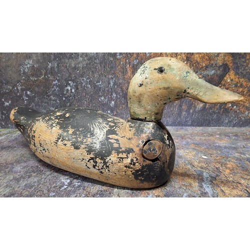 521 - Folk Art -a North American/Canadian carved and painted decoy duck, naively painted with black head a... 