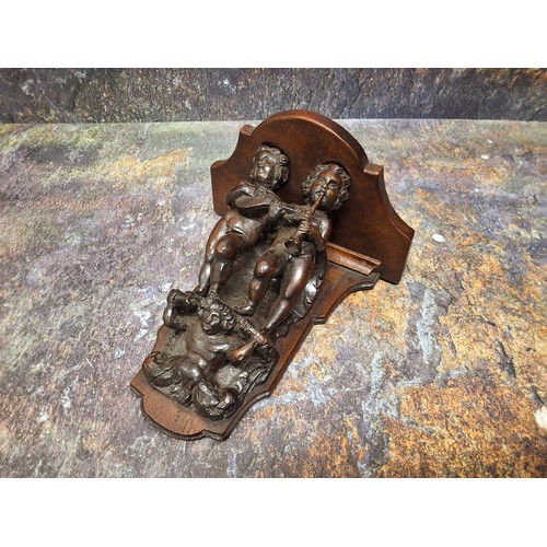 525 - A good '18th century' walnut wall bracket, carved with two musicians, supported by caryatid, 19cm hi... 