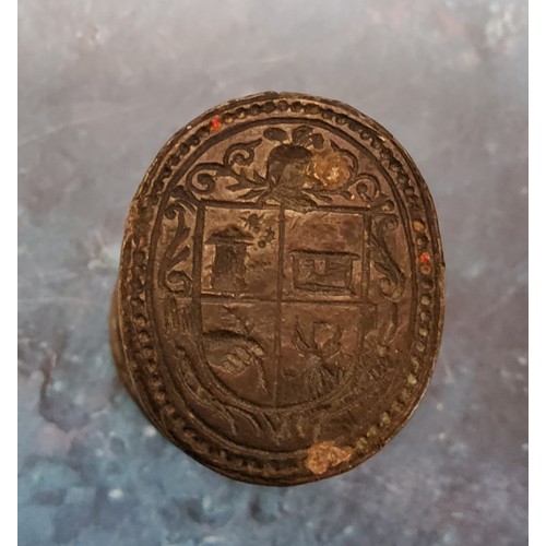 542 - An early 18th century bronze desk seal, substantial bun shaped cresting, oval matrix with armorial i... 