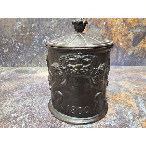 546 - A cast iron cylindrical tobacco jar, in relief with figures smoking long pipes, dated 1800, Inter Bi... 