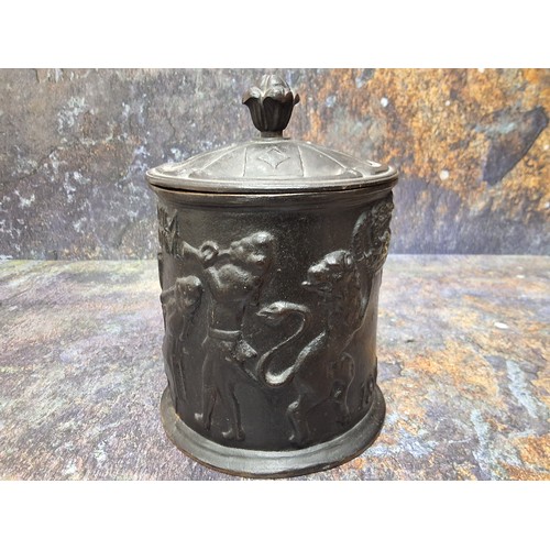 546 - A cast iron cylindrical tobacco jar, in relief with figures smoking long pipes, dated 1800, Inter Bi... 