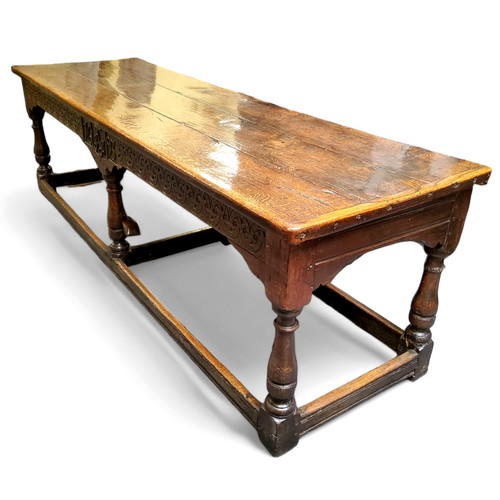 753 - A 17th century William & Mary oak and elm refectory table, the three plank top in well figured o... 