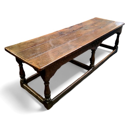 753 - A 17th century William & Mary oak and elm refectory table, the three plank top in well figured o... 