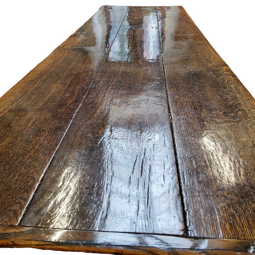 753 - A 17th century William & Mary oak and elm refectory table, the three plank top in well figured o... 