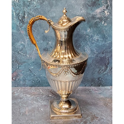 61 - A George III silver urnular hot water pot and cover, half fluted below ribbon tied swags, domed cove... 