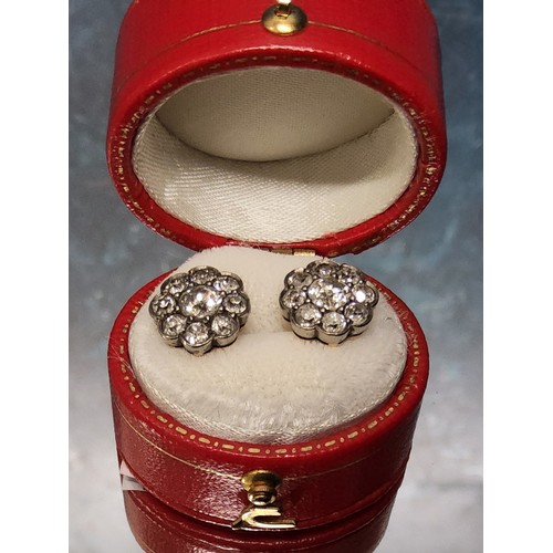 82 - A pair of 18ct gold & diamond cluster earrings, each set with a central round diamond approx. 0.... 