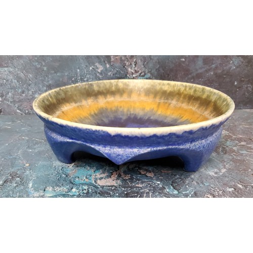 283 - A Ruskin matt crystalline footed bowl, decorated in a dripped blue, orange and tan glazes, i20.5cm d... 