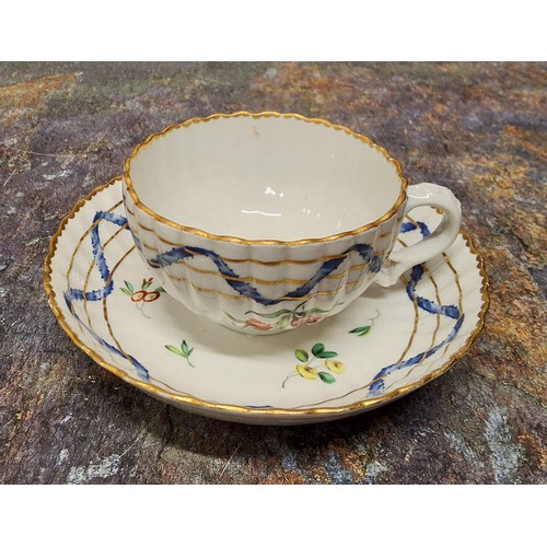 175 - A Bristol fluted teacup and saucer, from the Hilaire, Countess Nelson service, painted with colourfu... 