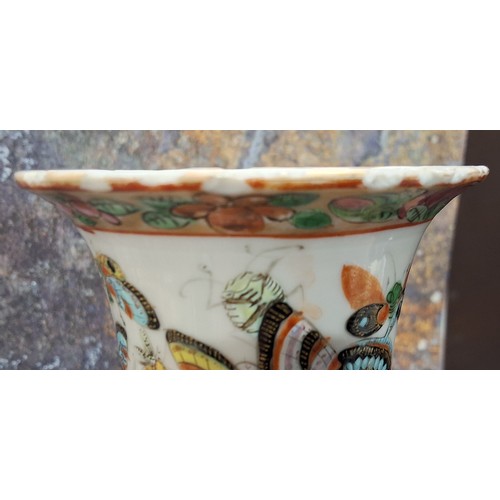 345 - A 19th century Chinese vase, decorated in polychrome with butterflies and insects, gilt mask handles... 