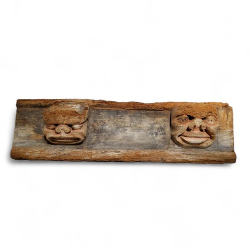 509 - A large 16th / 17th century Continental carved oak panel, traces of polychromy on the two masks, the... 