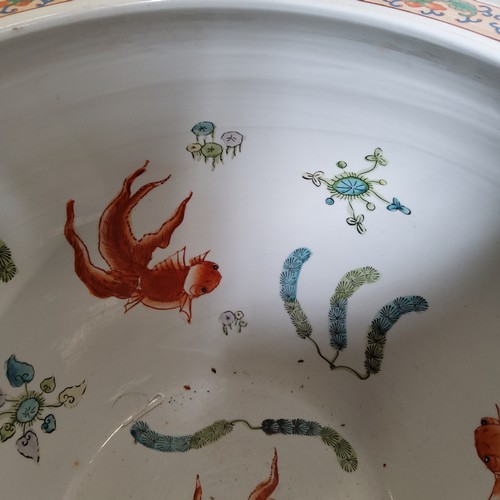 342 - A pair of 20th century Chinese fish bowls on stands, decorated to the exterior with birds amongst bl... 