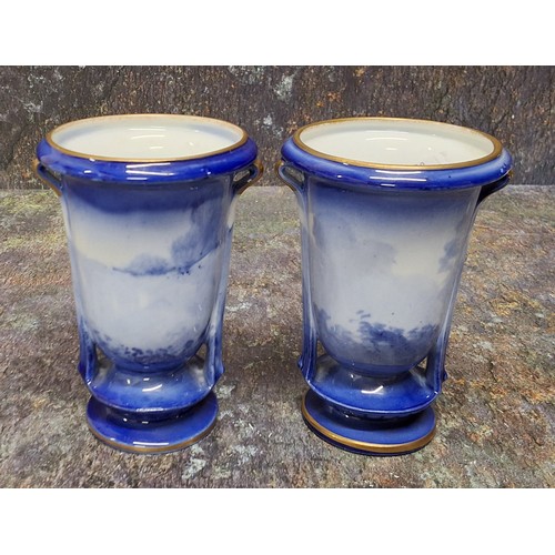 209 - A pair of Royal Doulton Blue Children urnular vases, printed and painted in tones of blue with young... 