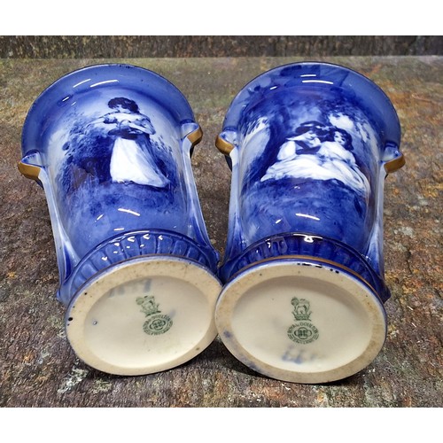 209 - A pair of Royal Doulton Blue Children urnular vases, printed and painted in tones of blue with young... 