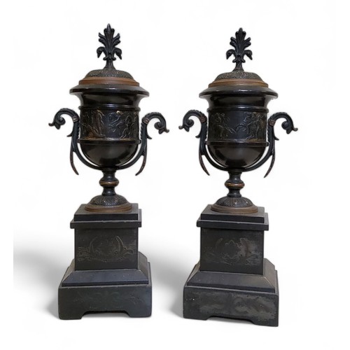 417 - A pair of late 19th century black marble side vases, of urnular form, banded in relief after the ant... 