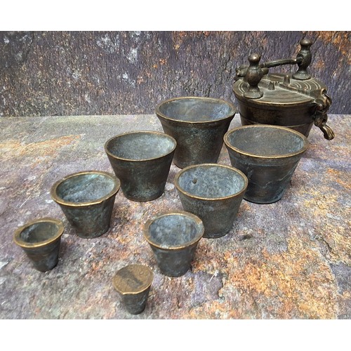 612 - A set of eight Nuremberg type bronze nesting cup weights, from 2/10 to 10oz Troy, the largest 7cm di... 