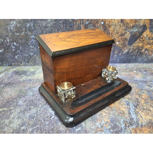 447 - A Victorian walnut and ebonised stationery box, hinged slope cover, the interior with letter racks, ... 