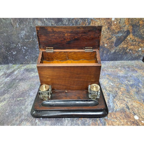 447 - A Victorian walnut and ebonised stationery box, hinged slope cover, the interior with letter racks, ... 