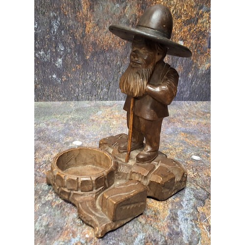 449 - A 19th century Black Forest desk tidy, as a dwarf standing by a well, 17cm high, c.1880