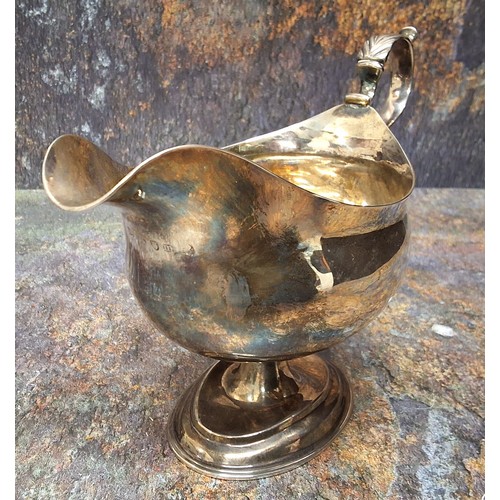 20 - A George III silver pedestal sauceboat, acanthus scroll handle, oval spreading base, 13cm high, Will... 