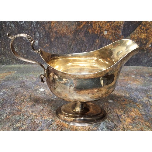 20 - A George III silver pedestal sauceboat, acanthus scroll handle, oval spreading base, 13cm high, Will... 