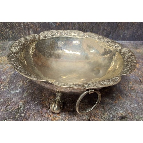 31 - A South American silver coloured metal shaped circular bowl, ring loop handles, ball and claw feet, ... 