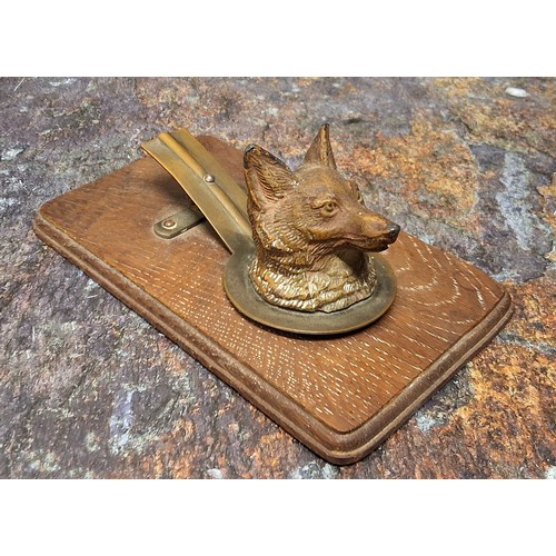 704 - An early 20th century cold painted letter clip, as a fox, wooden base, 14cm wide, c.1910