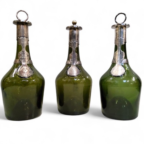 472 - Masonic Interest  - a set of three 18th century green glass bottles, kick-up pontil bases, each appl... 