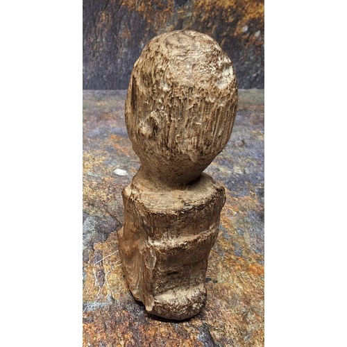 851 - An unusual fossilized wood carving, of a head, 12cm high