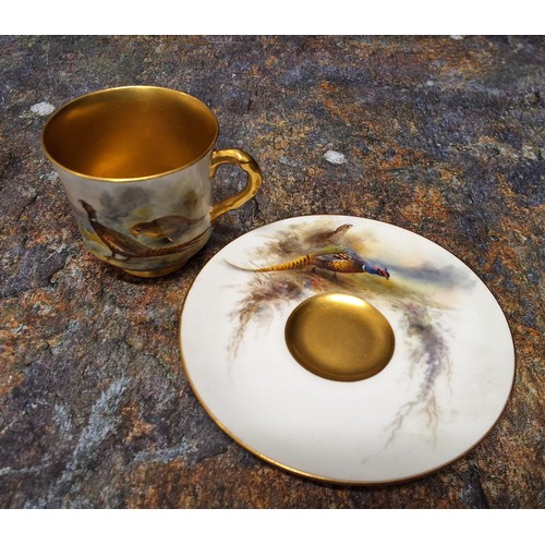 249 - A Royal Worcester demi-tasse cup and saucer,  painted by James Stinton signed, with a brace of pheas... 