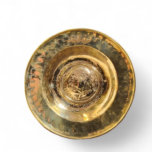 745 - An 18th century brass circular alms dish, in the Nuremberg manner, embossed with Marcus Tullius Cice... 