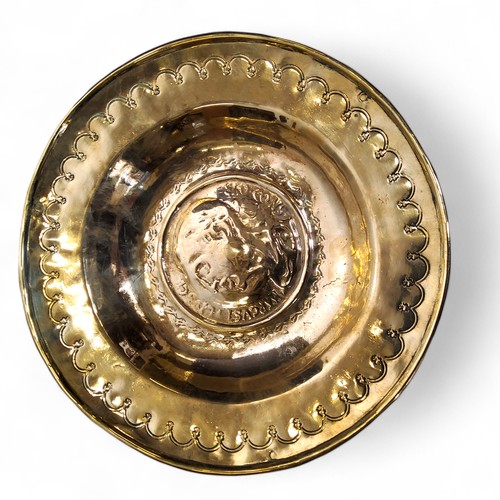 745 - An 18th century brass circular alms dish, in the Nuremberg manner, embossed with Marcus Tullius Cice... 