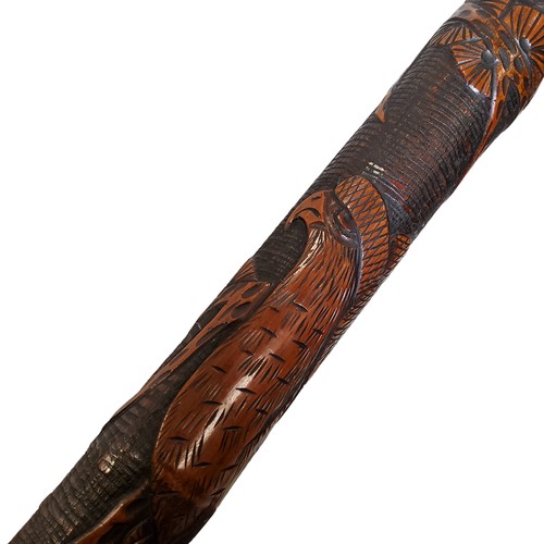 476 - A Japanese bamboo gentleman's walking cane, carved in relief with an eagle and blossoming prunus, ch... 