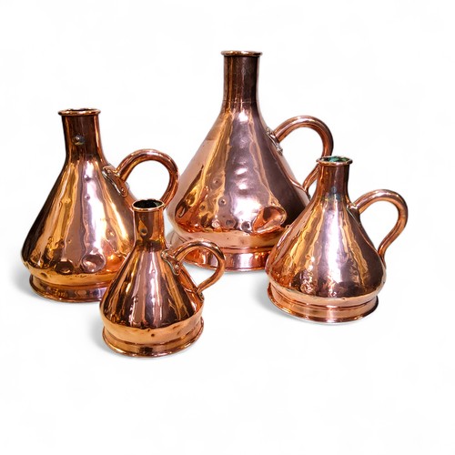 558 - A graduated set of four Victorian copper  haystack measures, loop handles, 2 gallon, 1 gallon, 1/2, ... 