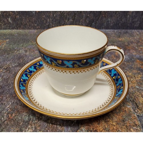 177 - A Minton cup and saucer,  painted from designs by Christopher Dresser,  with a banded scrolling styl... 