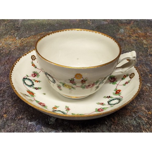 173 - A Bristol ogee teacup and saucer, decorated in polychrome with wreath and foliate swags, gilt dentil... 