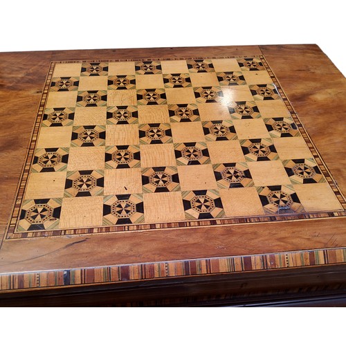 878 - A Victorian walnut work/games compendium,  inlaid in coloured woods with chessboard, conforming... 