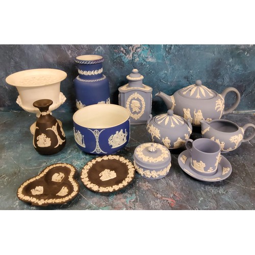 4 - A Wedgwood Blue Jasperware three piece tea service, each sprigged in white, the teapot 15cm high, im... 