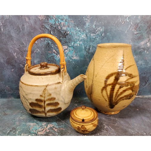 57 - A Studio Pottery teapot, in the Cornish manner, bamboo handle, 30cm high, seal mark;  a similar ovoi... 