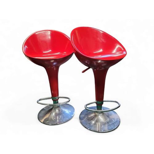 427 - A pair of red vacuum formed and chrome bar stools