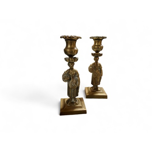 80 - A pair of Regency bronzed figural candlesticks, detachable floral nozzles, spreading square bases, 1... 