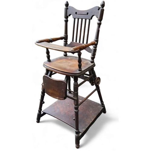 431 - A late 19th century oak high chair, spindle back, turned legs, pad feet.