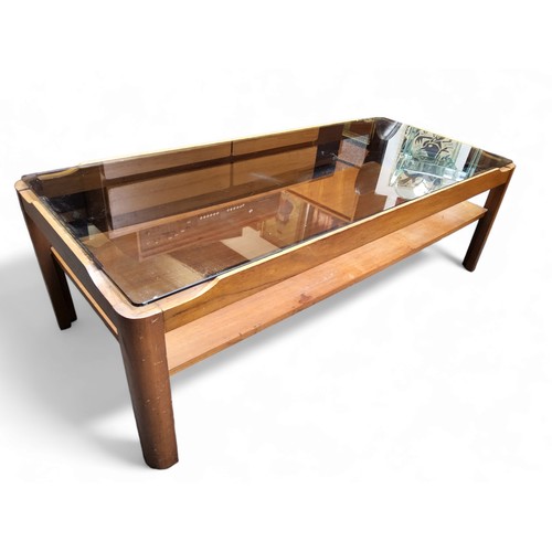 443 - A mid 20th century teak coffee table by Myer, inset smoked glass top, lower tier.