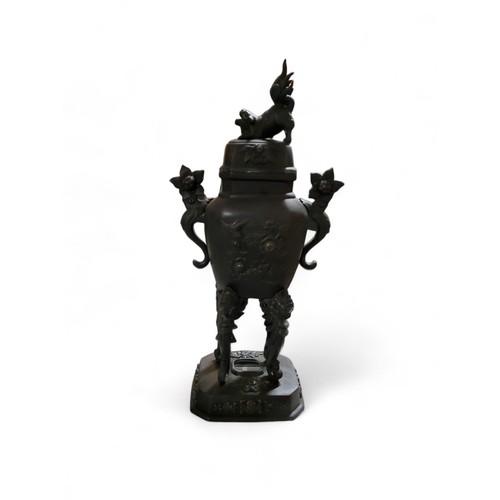 322 - A Japanese bronzed koro, Dog of Fo finial, scroll handles, high scroll legs, canted rectangular base... 