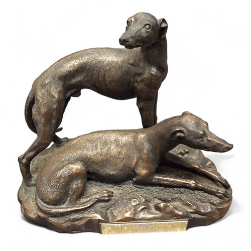 125 - A resin bronzed figure, of a greyhound, oval base, 23cm high;  another, greyhound pair, 19cm hi... 