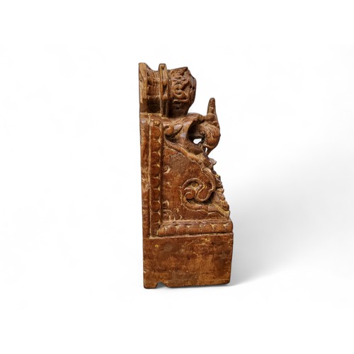 473 - A 19th century  Indian teak corbel, carved with stylised peacock, 258.5cm high, 18cm wide