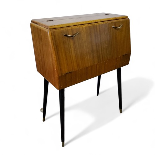 468 - A mid 20th century cocktail cabinet by Rivington, the fall front revealing ilustrated mirror back wi... 