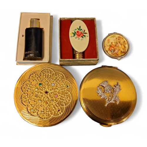 315 - A Kigu compact, the cover mounted with a white thistle set with marcasite; another gilt metal compac... 